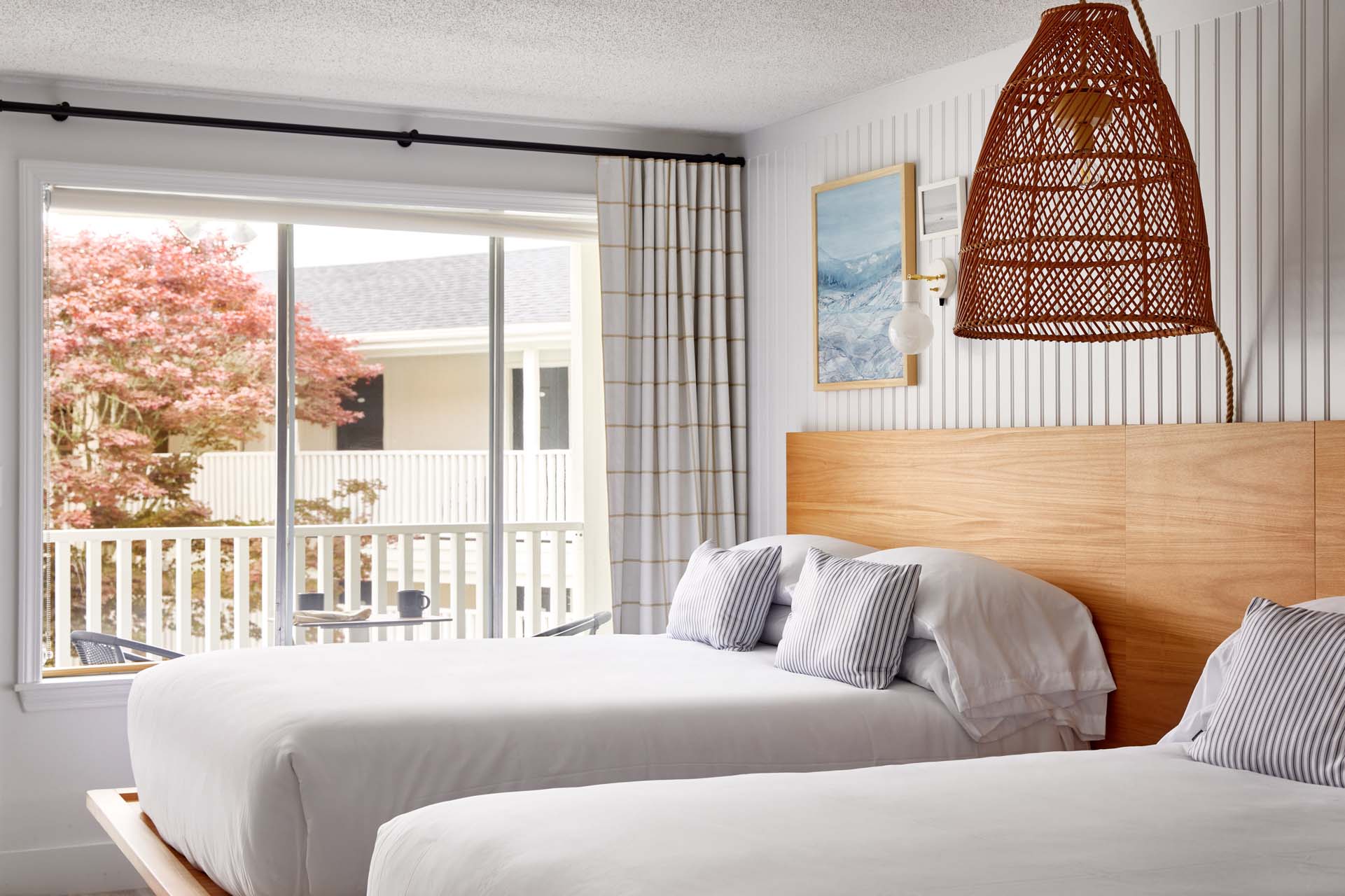 Two Queen guest room with two queen beds beside a window
