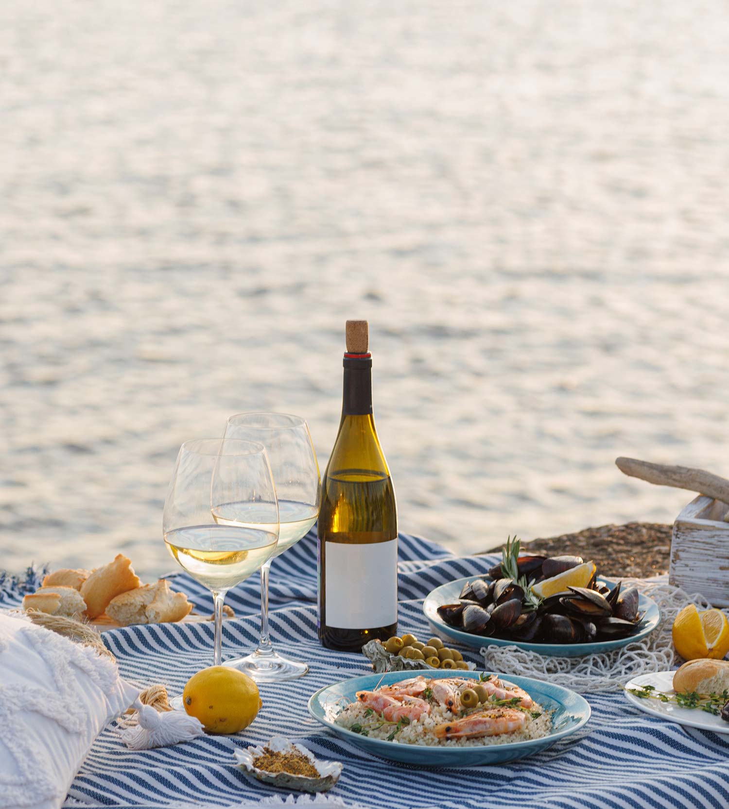 A table of seafood and wine beside the sea
